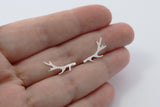 silver antler studs in a hand